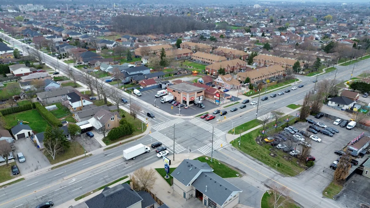 High aerial view of the Barton Street East and Dewitt Road junction, with No. 520 and its lot at centre among houses and townhouses