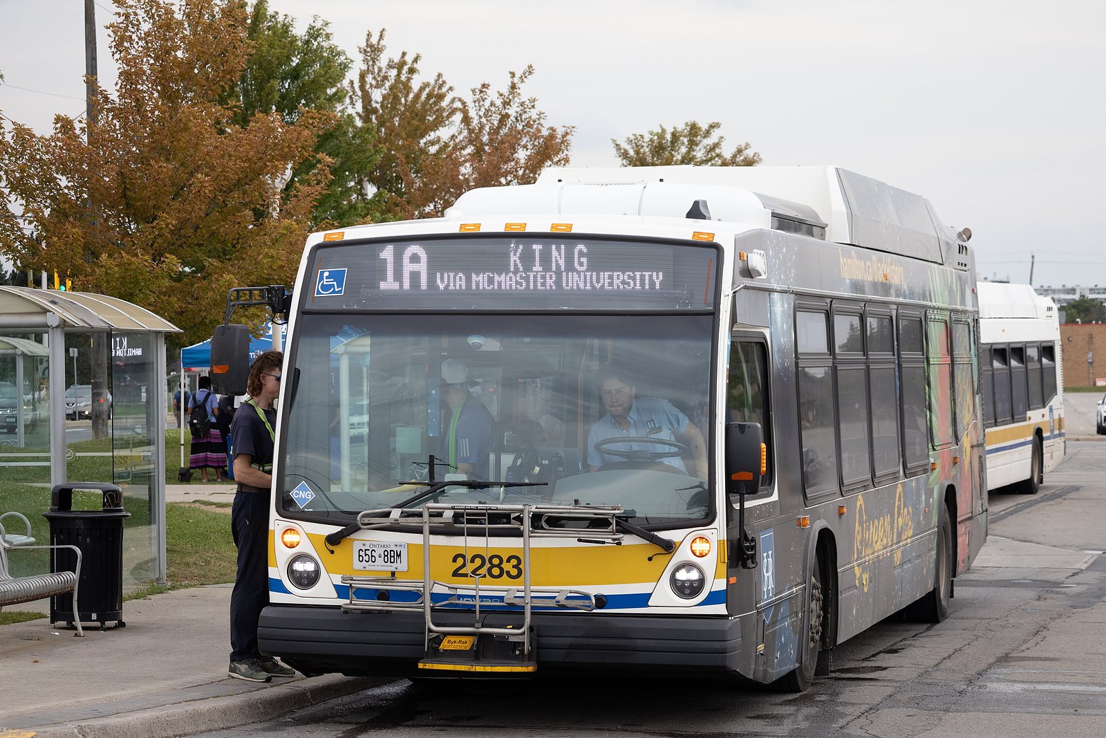 A yellow and white Hamilton Street Railway bus on route 1A King at a suburban terminal