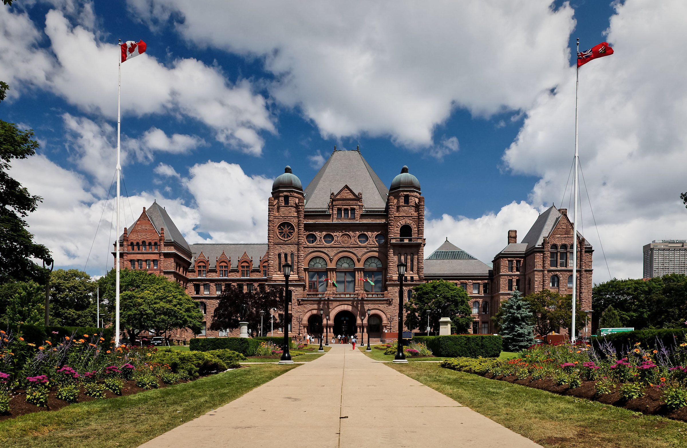 The Ontario Legislative Building at Queen’s Park, Toronto, at the end of a garden path under a blue sky
