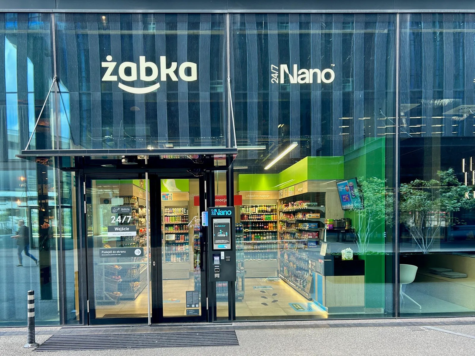 Street-facing Żabka Nano checkout-free store behind a glass facade in Katowice